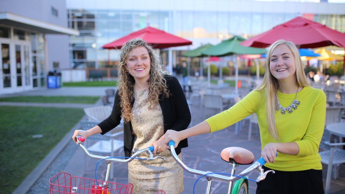 Mackenzie Thomas and Jane Hall stand next to bicycles at the Googleplex in California