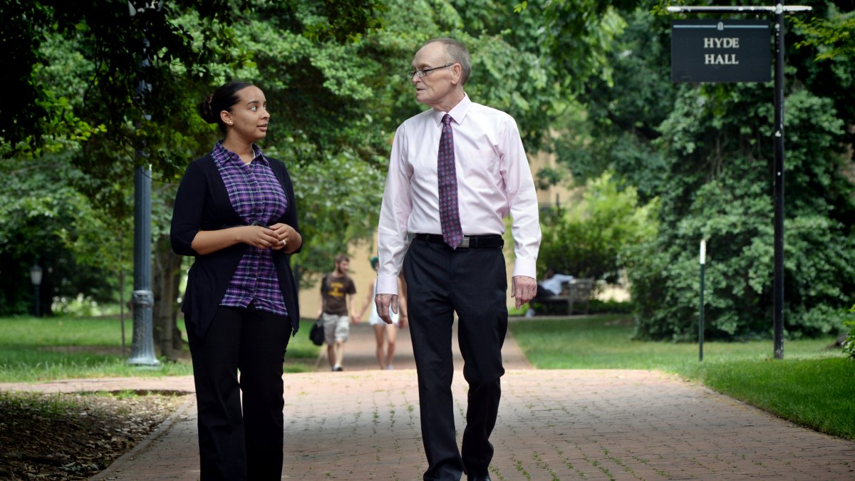 Precious Barnes and Fred Clark walk on a path at UNC-Chapel Hill