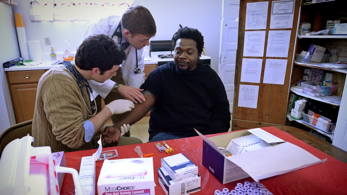 Medical students take a blood sample.