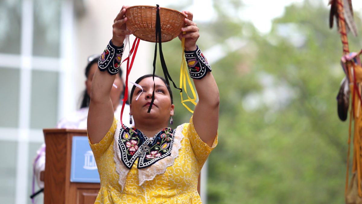 Qua Lynch performs the Corn Harvest Dance during the UNC American Indian Center's rededication of artist Senora Lynch's 