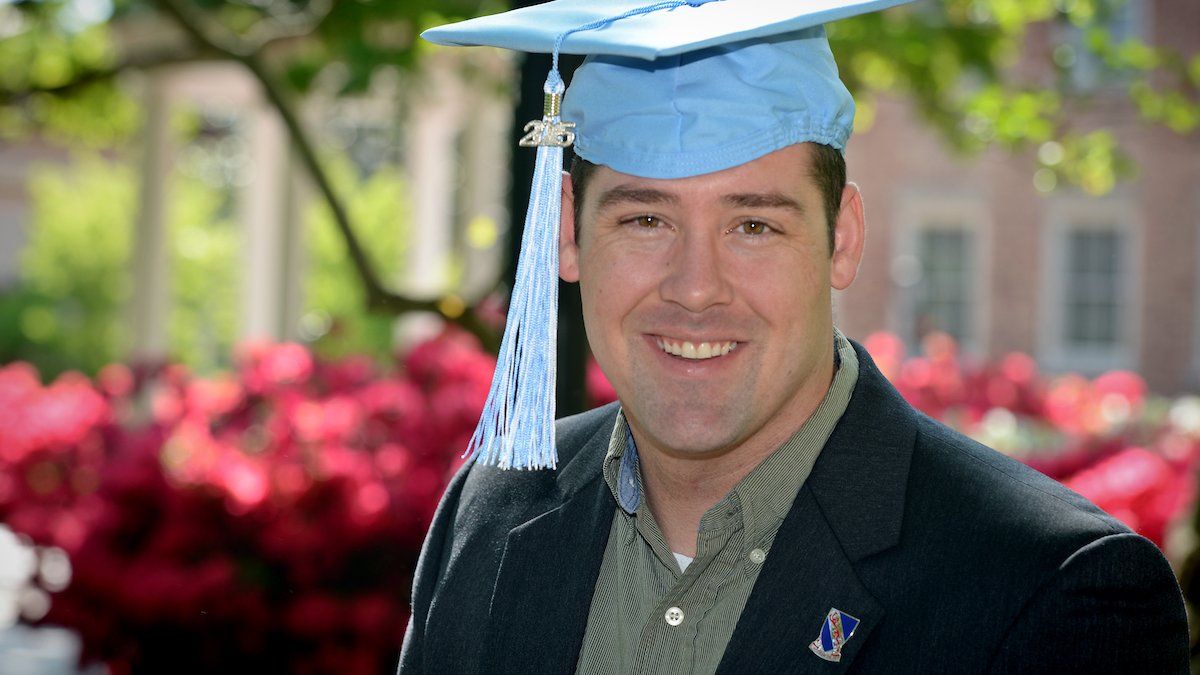 Jacob HInton wears a Carolina blue graduation cap