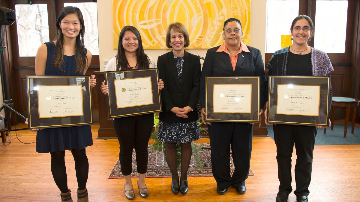 Chancellor Folt stands with the four awardies.