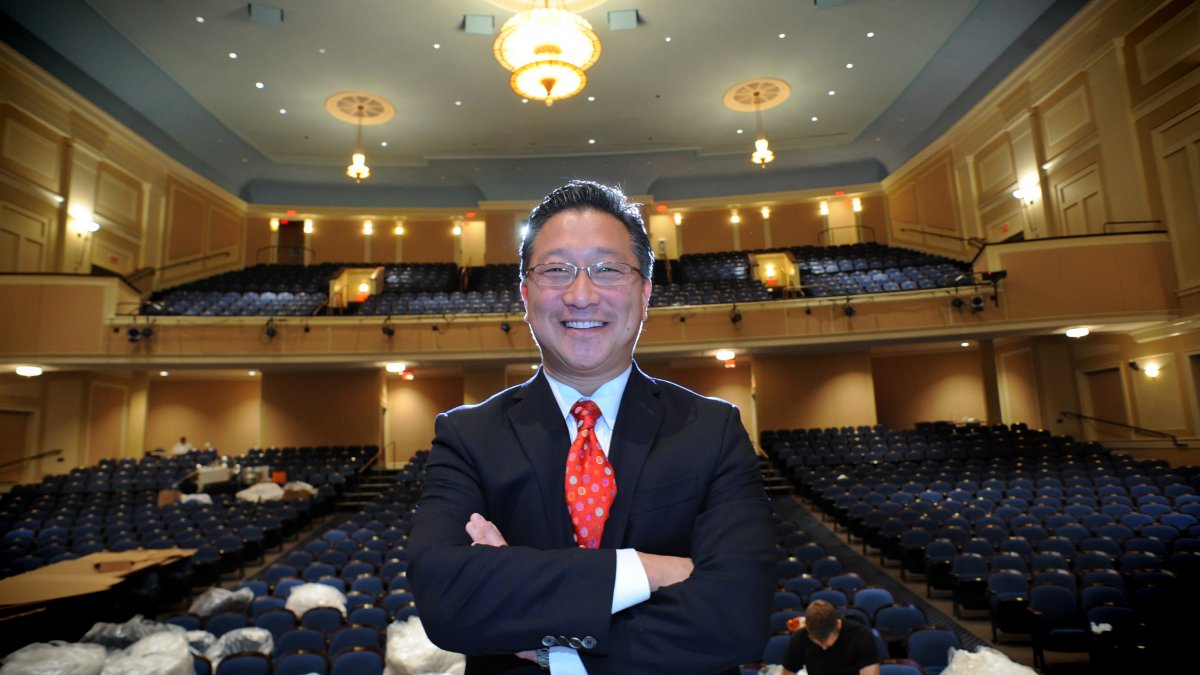 Emil Kang stands on stage in Memorial Hall.