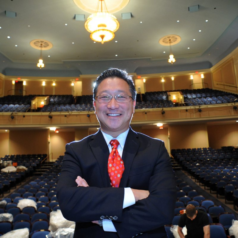 Emil Kang stands on stage in Memorial Hall.