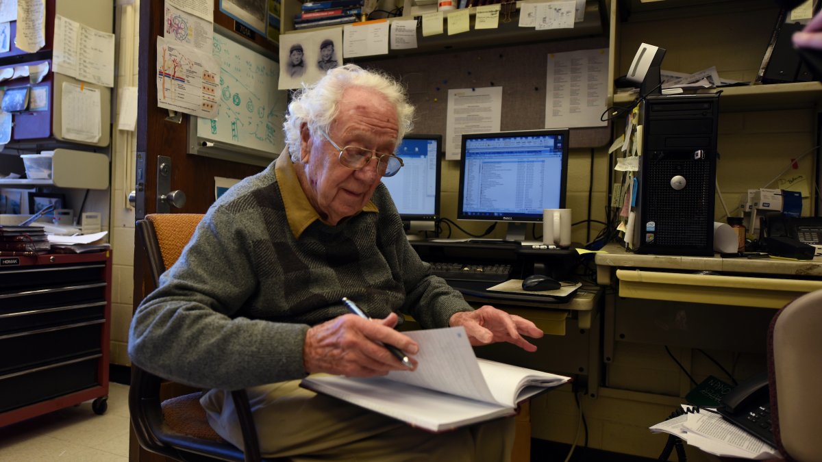 Dr. Oliver Smithies sits with an open notebook