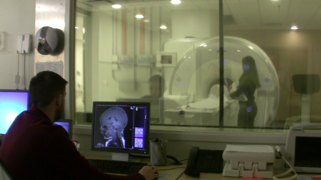Researcher looks at imaging of brain.