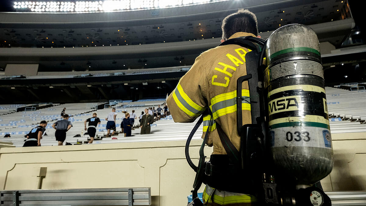 Firefighter walks stairs at Kenan Stadium