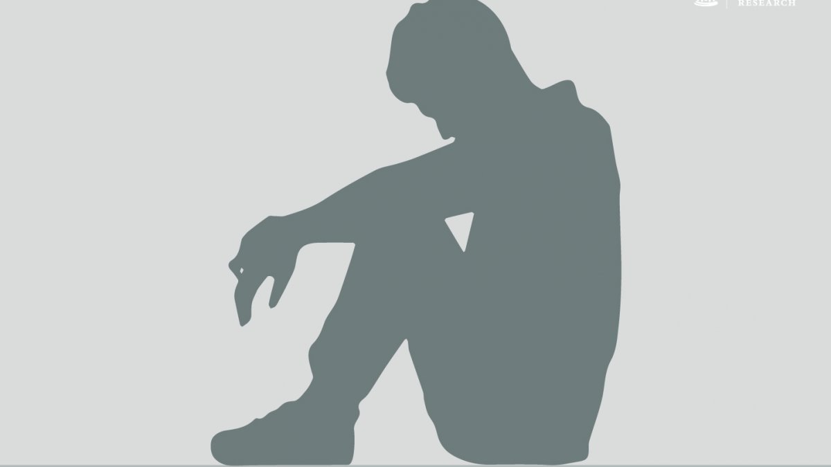 graphic of a a person sitting on the floor with knees up and head down