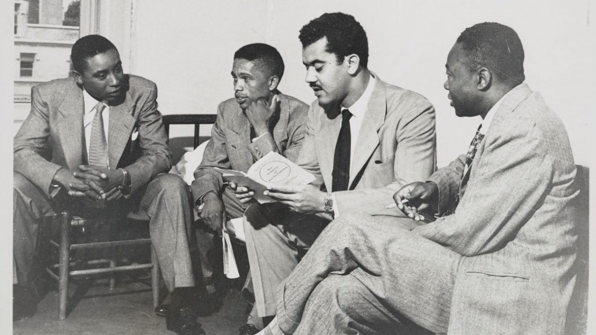 Floyd McKissick, J. Kenneth Lee, Harvey Beech and James Lassiter sit in chairs