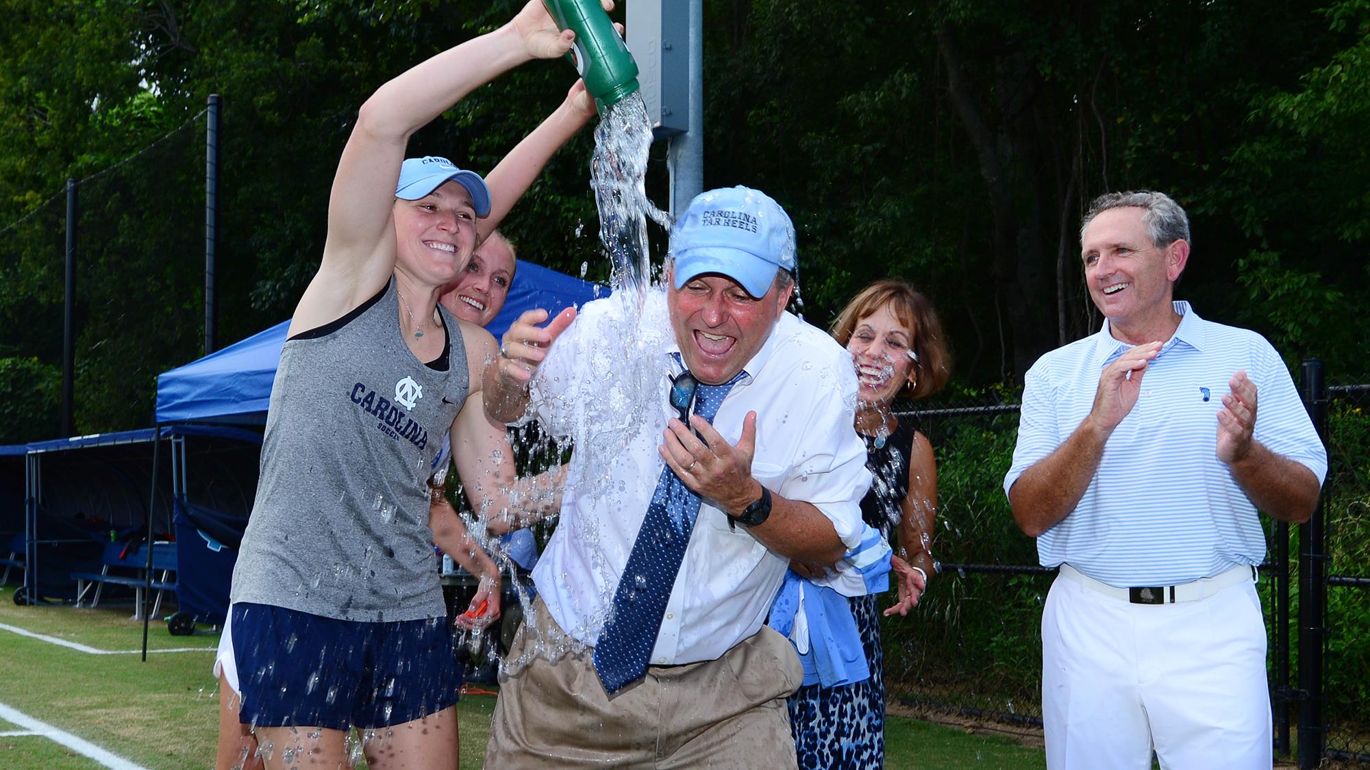 Players pour water on coach Anson Dorrance