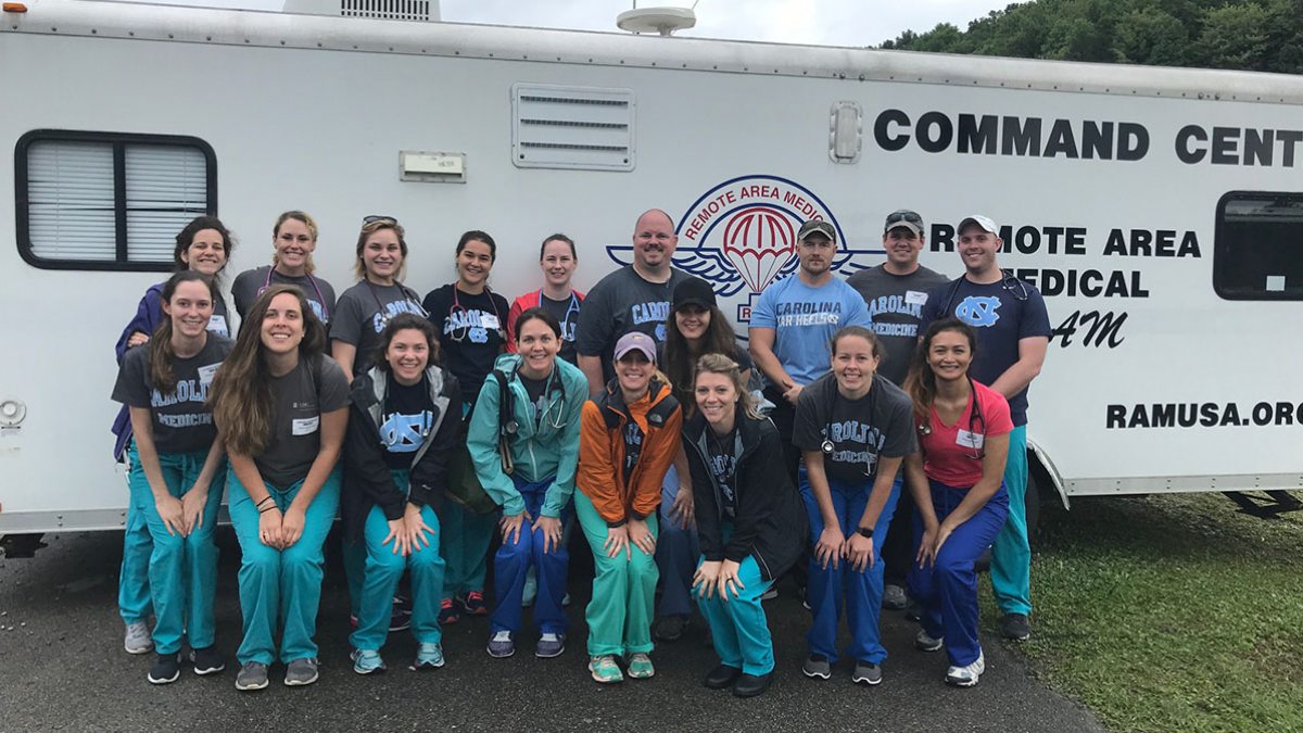 Students pose for a photo outside a mobile medical clinic.