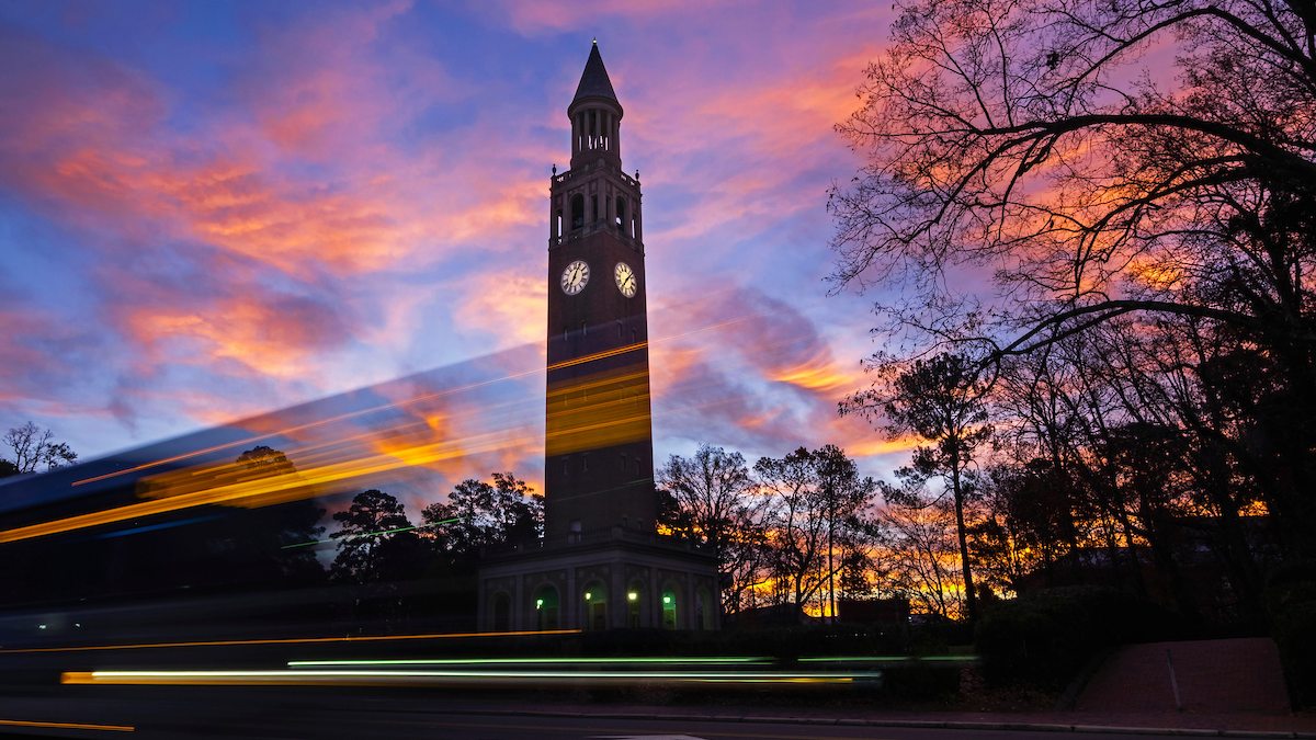Cars drive past the Bell Tower.