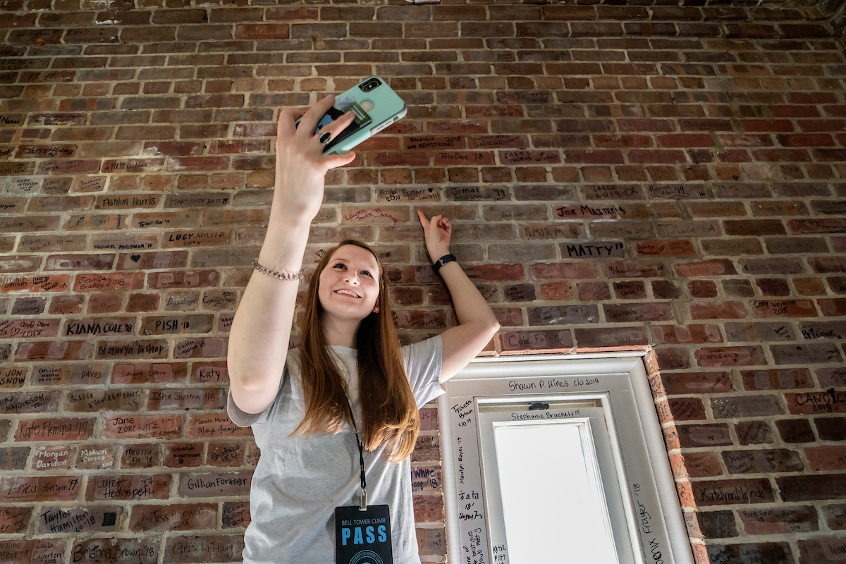 A woman takes a selfie inside the bell tower.