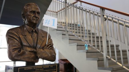 A bust of Banks Kerr holds a No. 1 flag.