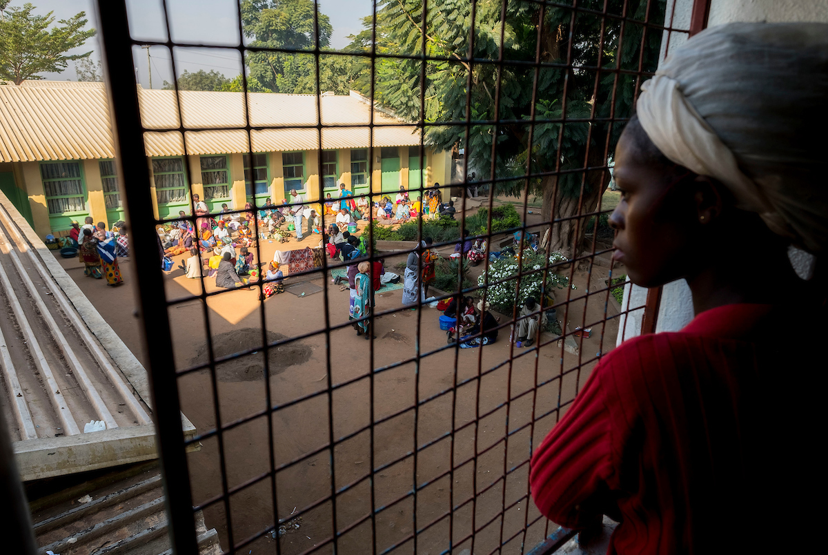 A woman overlooks courtyard in Malawi