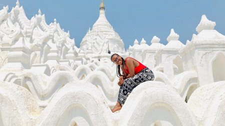 Mya Doggett in front of a white pagoda in Myanmar
