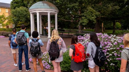 Students line up near the Old Well to take a drink from the fountain.