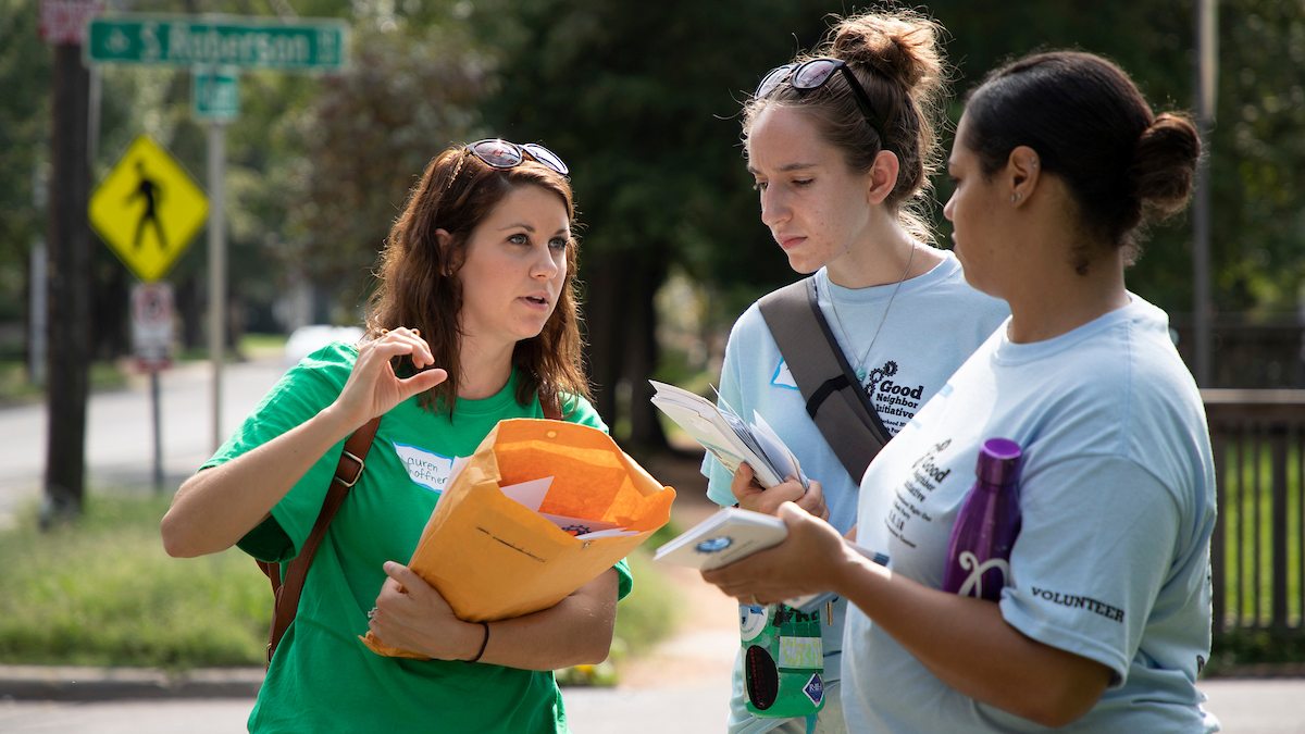 Three women talk during the Neighborhood Walk