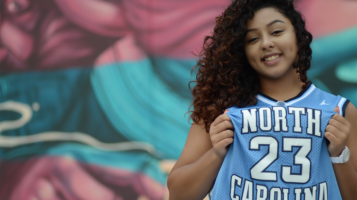 Epley poses in a Carolina Blue basketball jersey