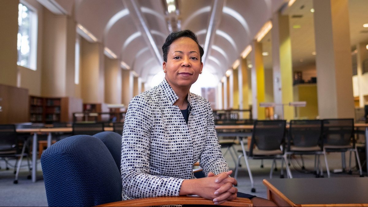 Elaine Westbrook sits in a library.