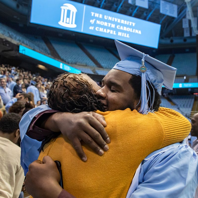 A graduate hugs their mom.