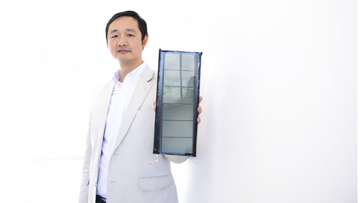 Jinsong Huang holds a solar panel.