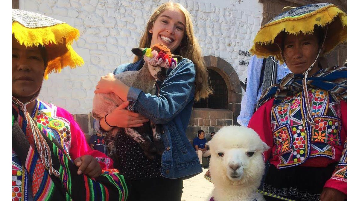 Erin Hager holds an alpaca in Chile.