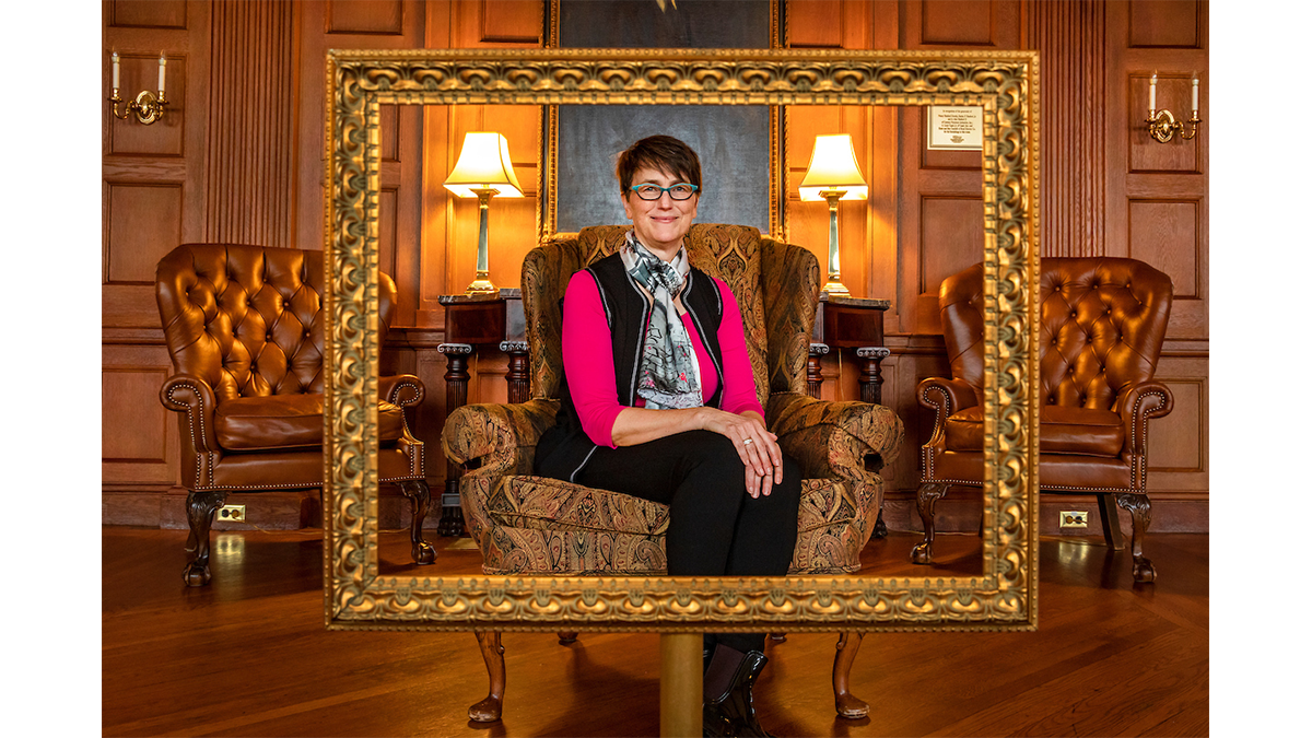 Barbara Fredrickson sits in a decorative chair in a lounge