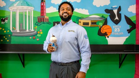 Antonio McBroom holds a milkshake at the Chapel Hill Ben and Jerry's shop.