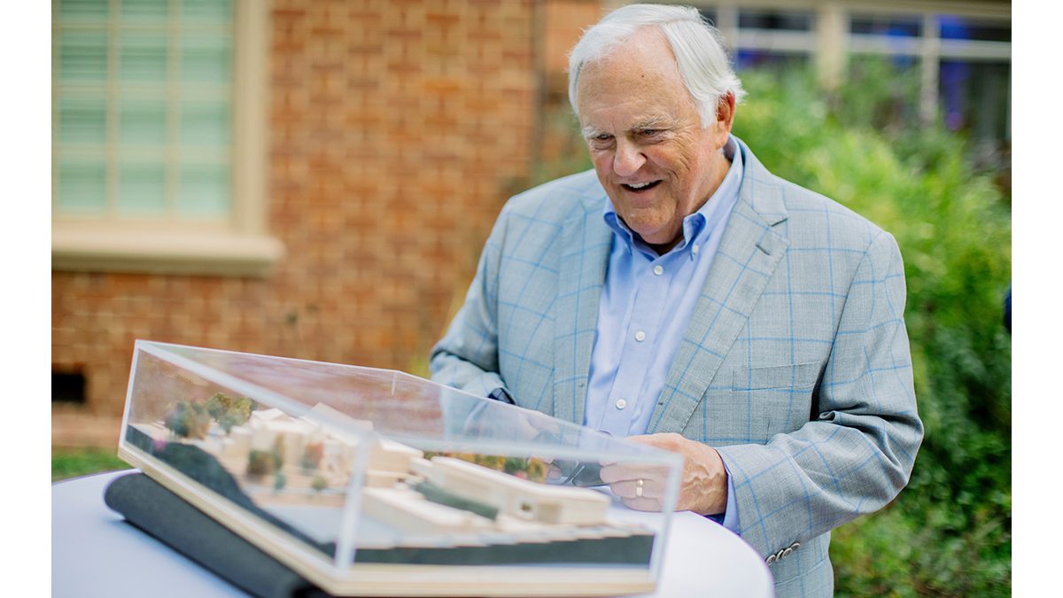 Steve Bell examines a model for a proposed new building.