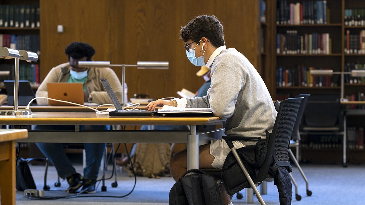 A student sitting at a table studying.