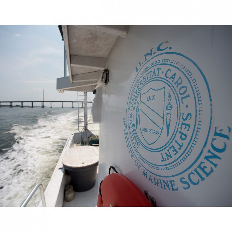 A boat with the UNC seal painted on the side.
