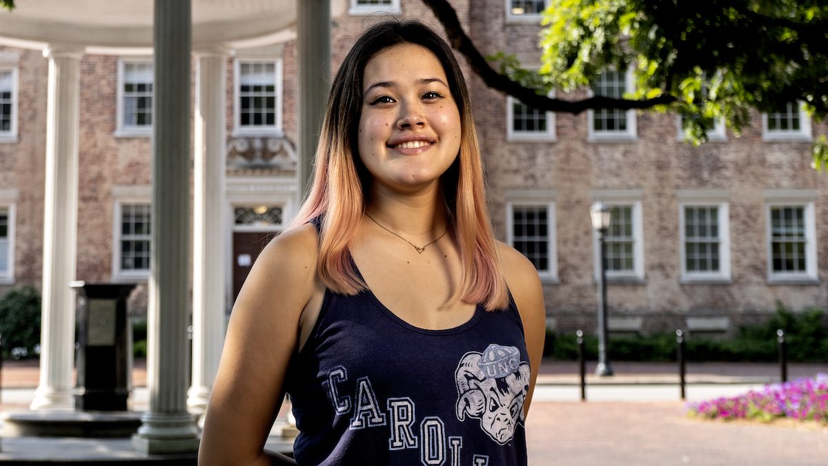 Carolina senior Alyssa Cooper poses in front of the Old Well.