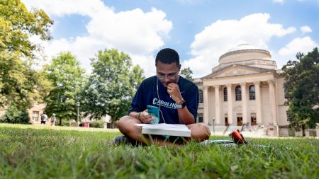 A student sitting on polk place.