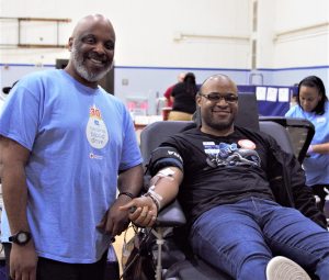 Donor giving blood at Holiday Carolina Blood Drive.
