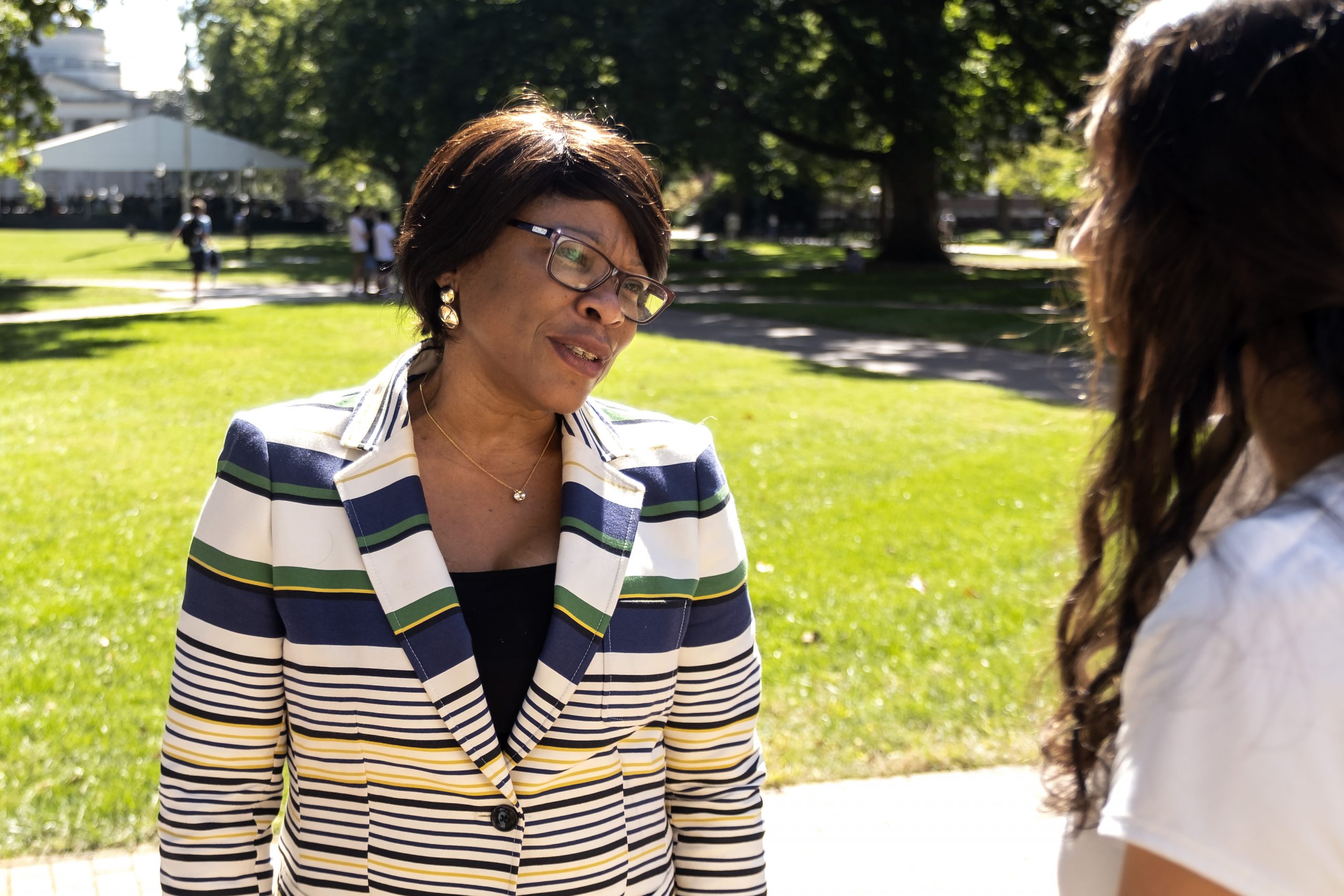 Anita Brown-Graham talks to a student outside.