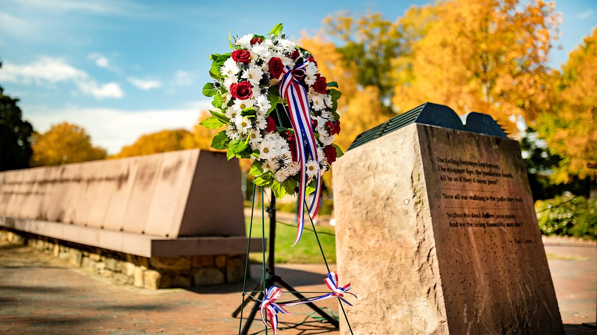 A wreath by a military memorial.