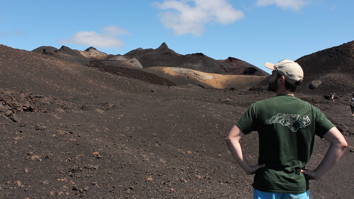 Will Larsen standing in front of a volcano.