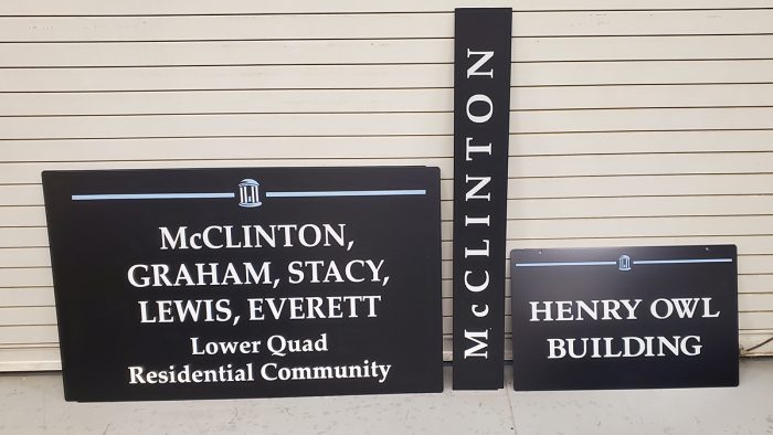 The black metal signs with the new names are ready to be installed.