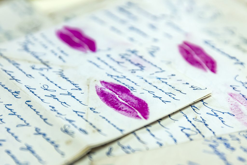Letters from the 1800's with cursive writing and lipstick kisses