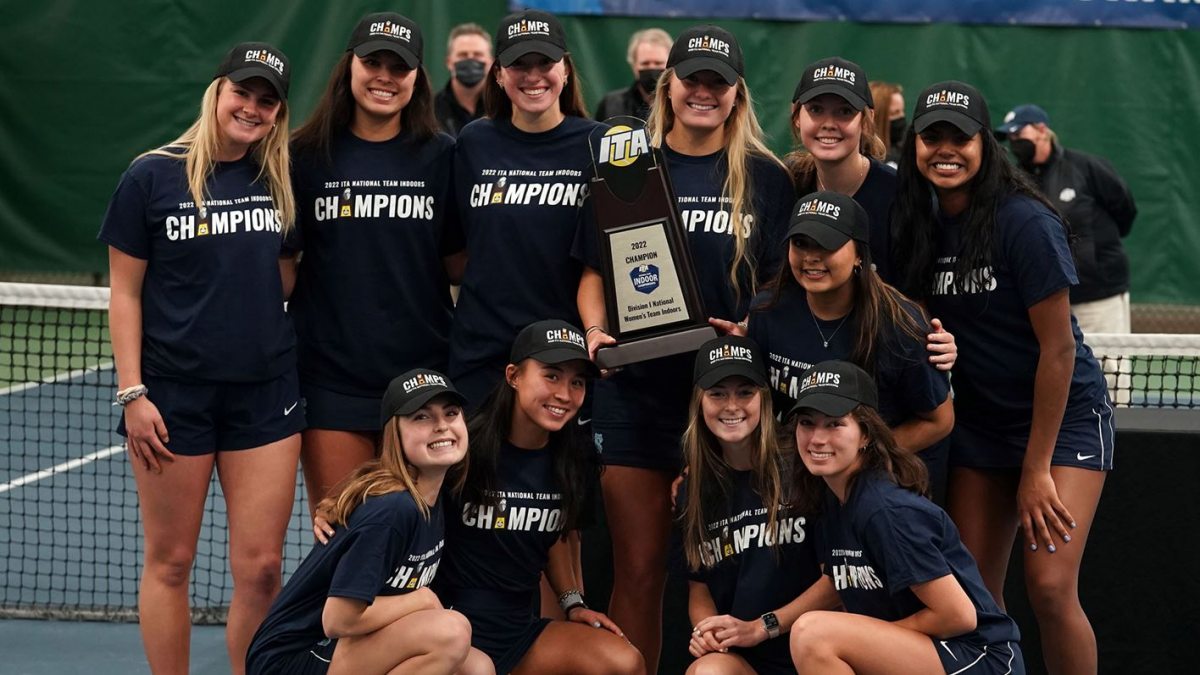The women's tennis team with a trophy.