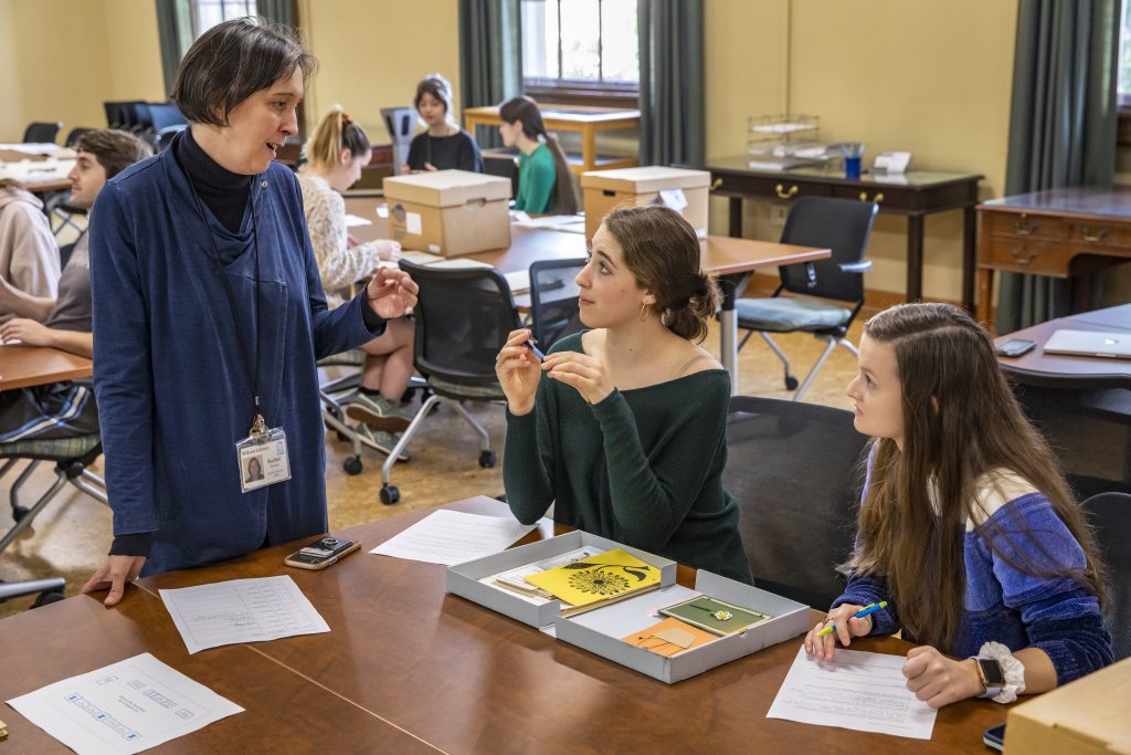 Special collections exhibitions coordinator Rachel Reynolds works with Emily Orland (center) and her classmate Brynn Garner(right) at Wilson Library on Jan. 16, 2020. (Johnny Andrews/UNC-Chapel Hill)
