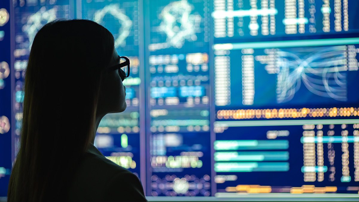 A women looking at data on a screen.