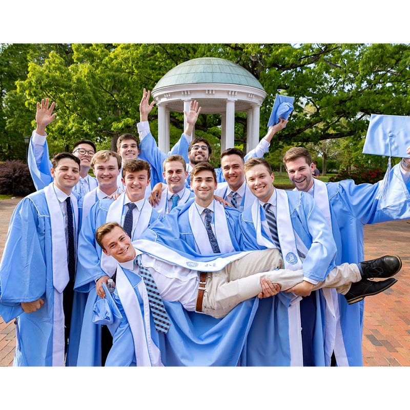 Graduating seniors pose for pictures at the Old Well on April 21, 2022, on the campus of the University of North Carolina at Chapel Hill.