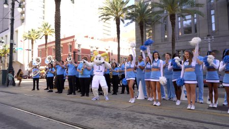 The UNC band playing on a street.