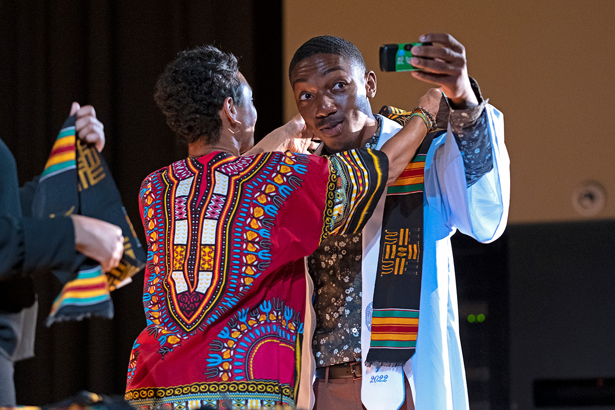 A student taking a selfie on stage.