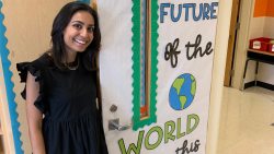 Asha Patel standing by her classroom door.