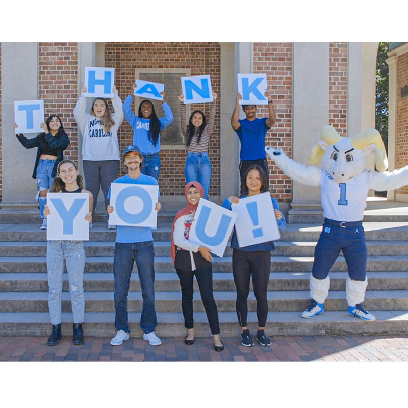 Students holding a sign that says thank you.