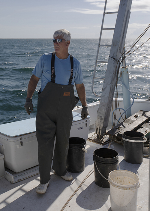Stacy Davis stands on the deck of the research vessel Capricorn while on a shark-tagging trip.