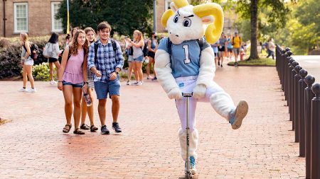 Rameses rides a scooter around campus on the first day of classes in 2021.